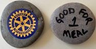 A rock with the Rotary logo on one side and \"good for one meal\" on the other
